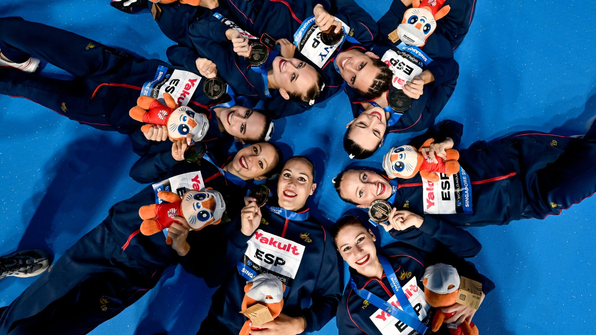 Athletes of team Spain celebrate after winning the bronze medal in the artistic swimming Team Acrobatic Final during the 22nd World Aquatics Championships at the WAC Arena in Singapore (Singapore), July 25, 2025.